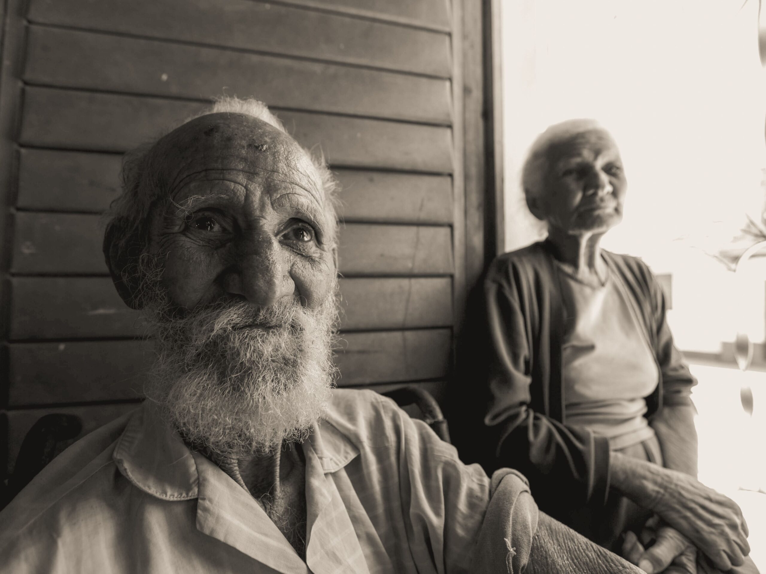 Elderly couple sitting together, capturing a moment of contentment and companionship.